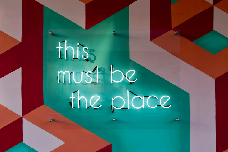 Neon sign reading “The Place”.