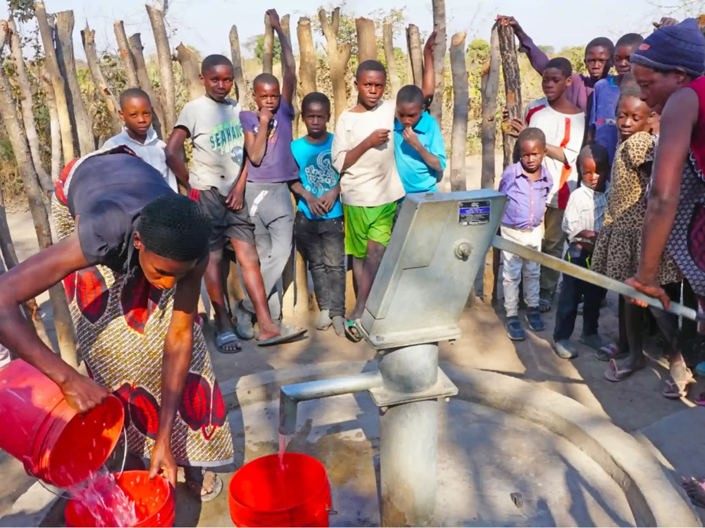 Villagers gathering clean water from the new well.